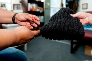 Close up photo of someone receiving a hat