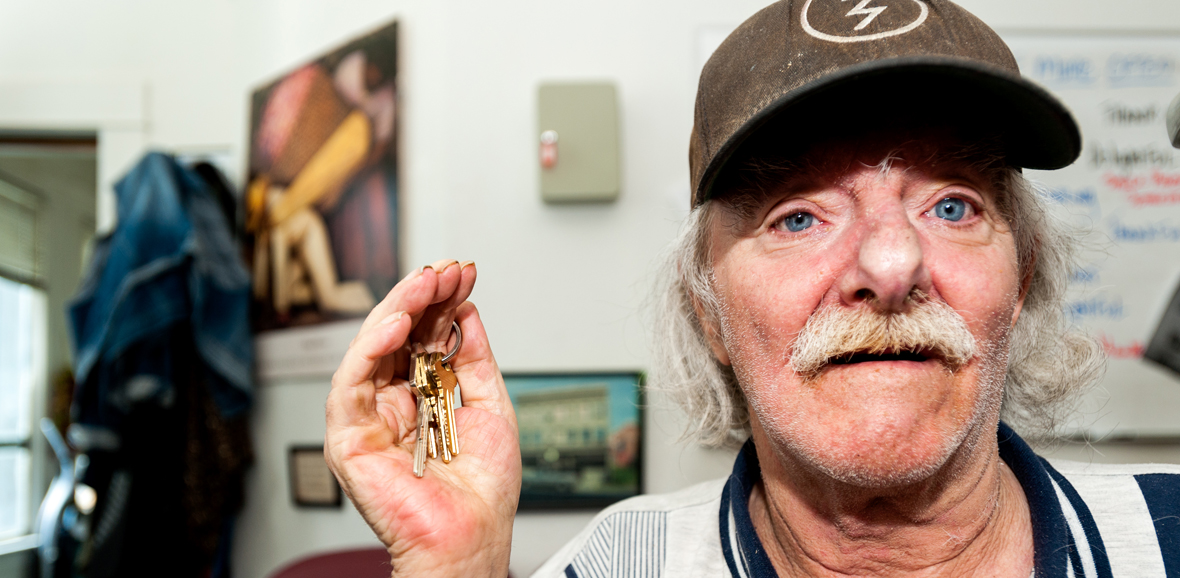 Photo of man smiling and holding keys.