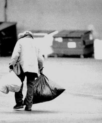 Photo of homeless man with many bags