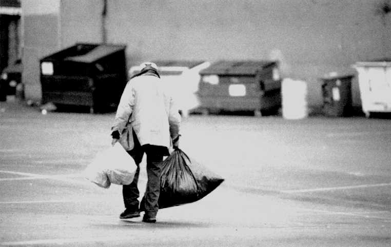 Photo of homeless man with many bags